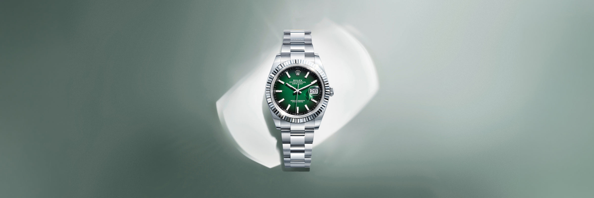 Rolex Datejust in white Rolesor with a green dial set against a light green background