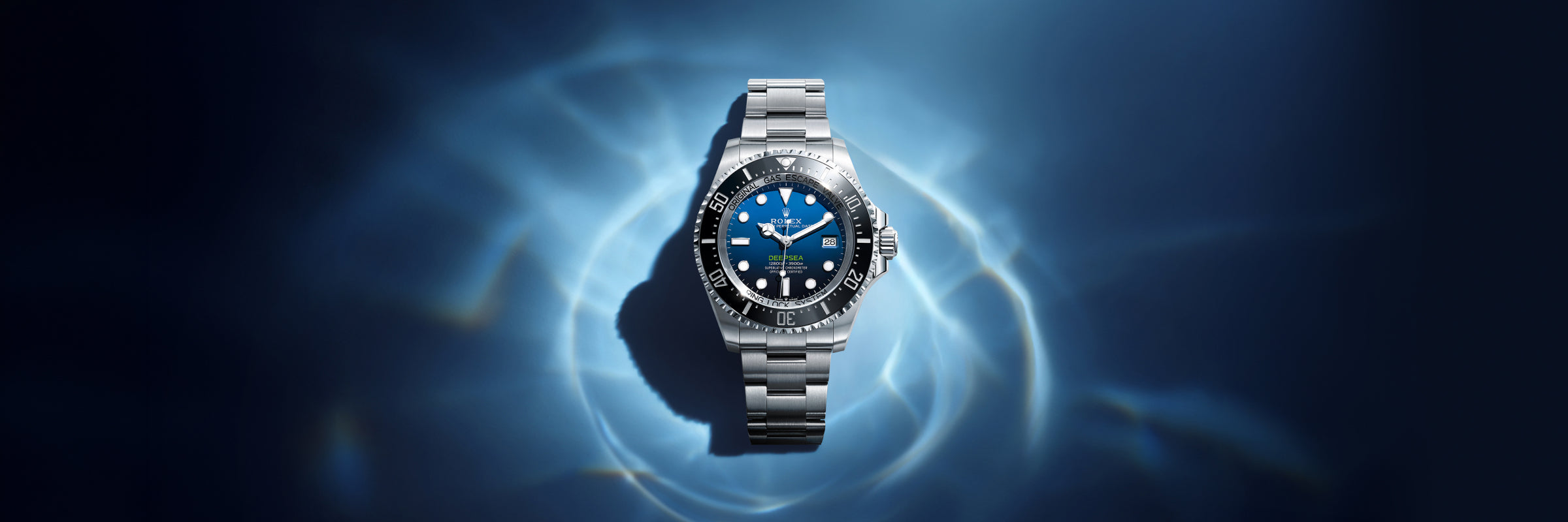 Rolex Deepsea in Oystersteel with a D-blue dial, which is gradated in colour to mimic the ocean's depth, set against a dark, watery background