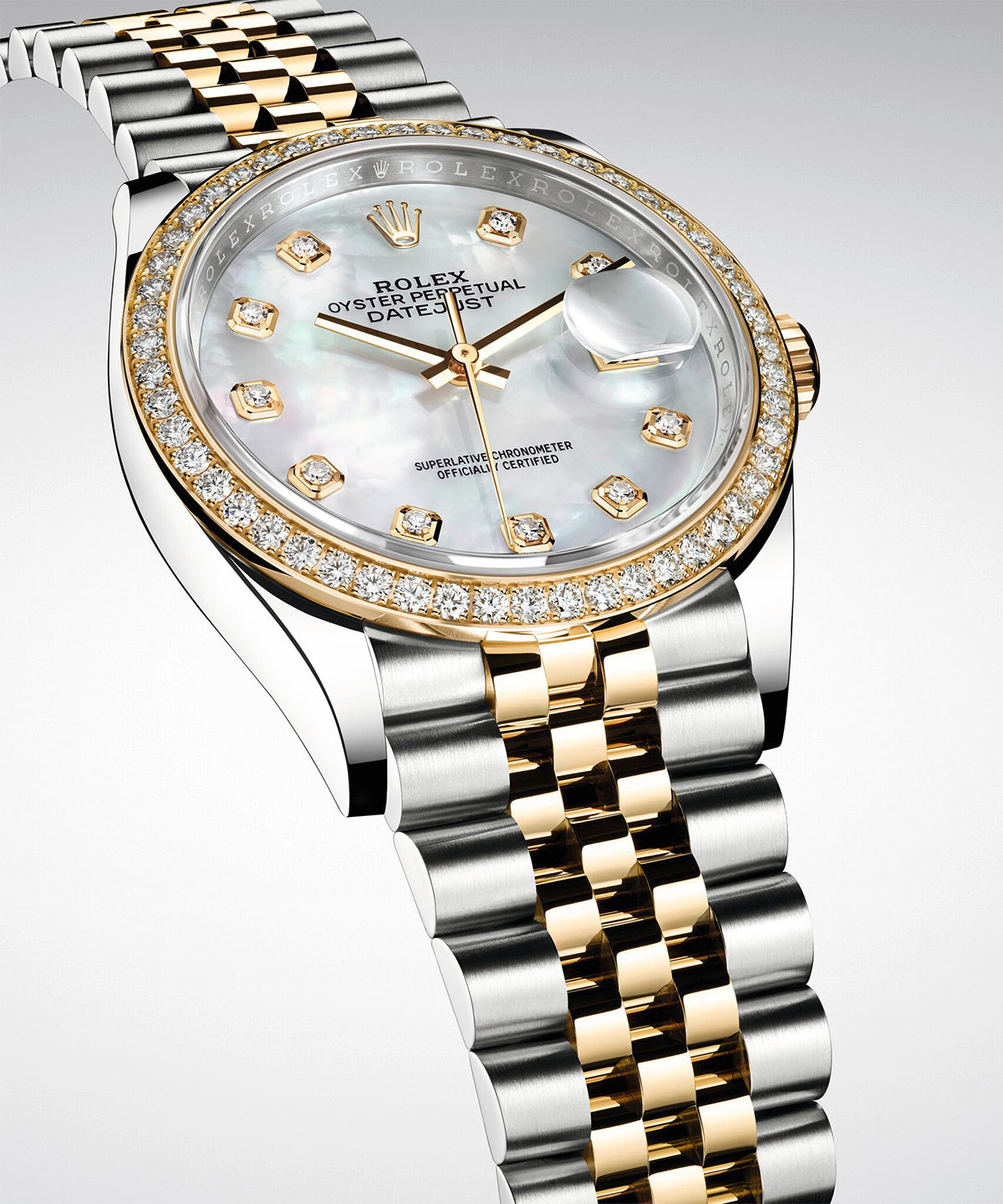 A Rolex Datejust in yellow Rolesor with a diamond-set, mother-of-pearl dial, set against a light grey background