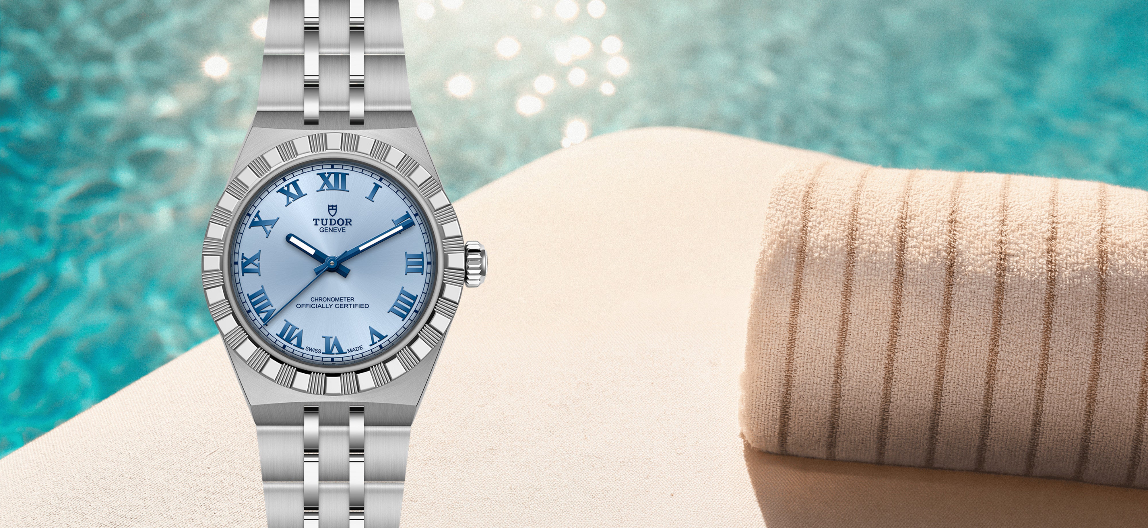 A Tudor Royal wristwatch, displayed poolside next to a beige towel