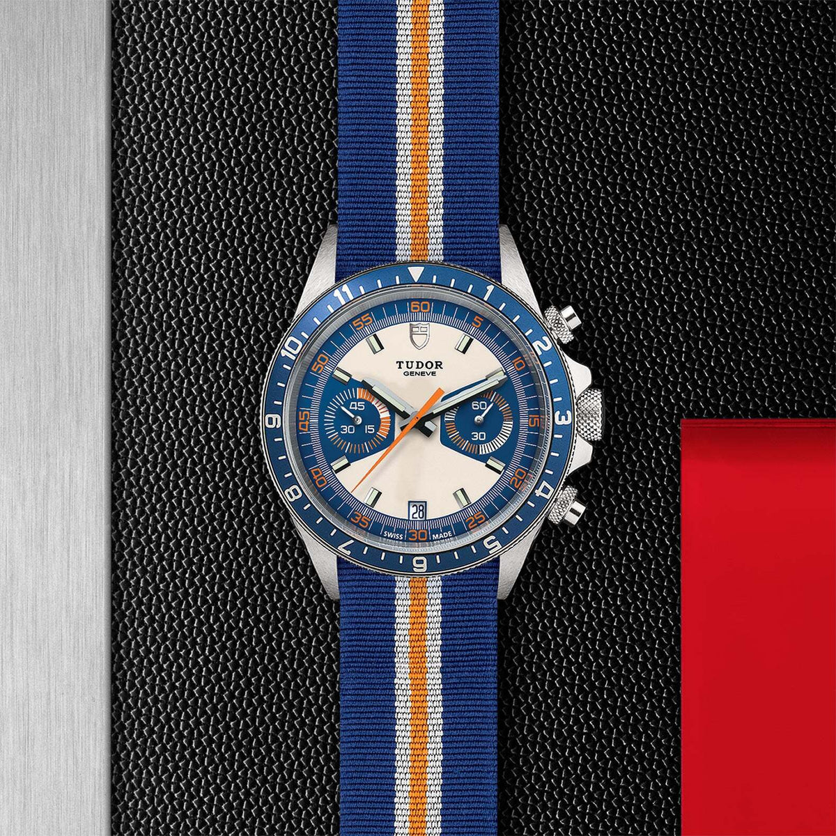 Tudor Heritage Chrono 42mm steel case with a opaline and blue dial and a fabric strap - Howard Fine Jewellers