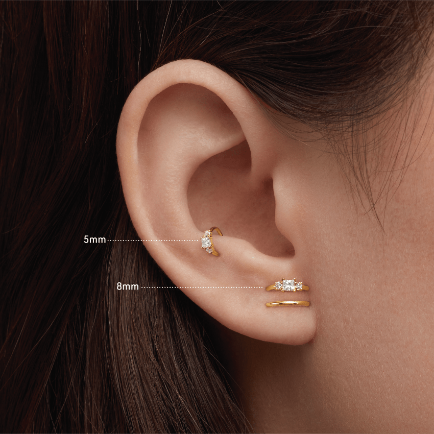 Video Thumbnail: Maria Tash Yellow Gold Classic Elegant Design Resembles the Style of an Engagement Ring the Clicker Ring Features a Diamond Flanked by Two Smaller Diamonds Princess 0 Diamond - Maria Tash 18k Yellow Gold 2mm Diamond Princess Hoop Earring
