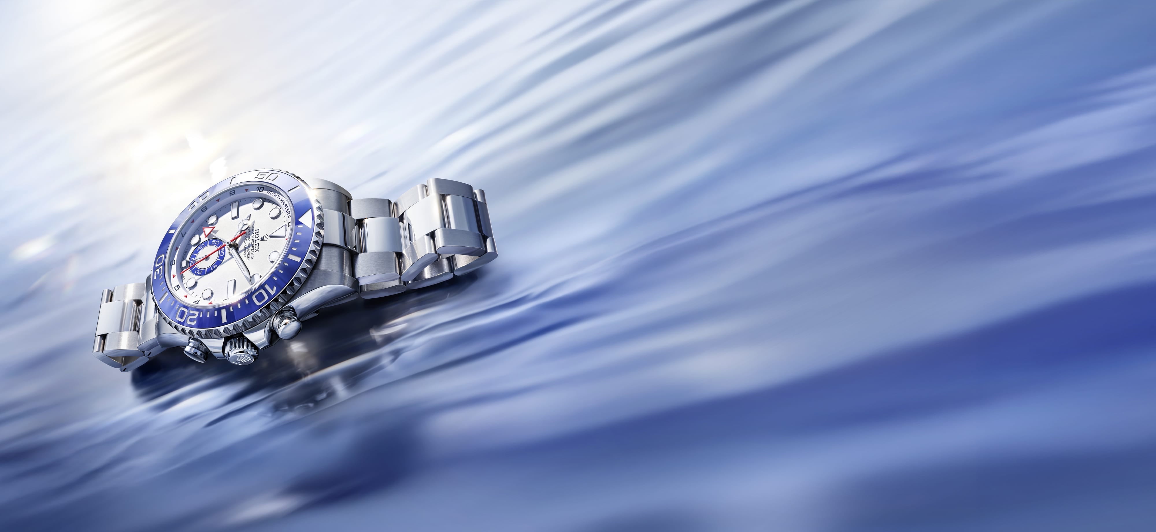 A Rolex Yacht-Master II regatta timer, with programmable mechanical memory, resting atop a sunlit wave.