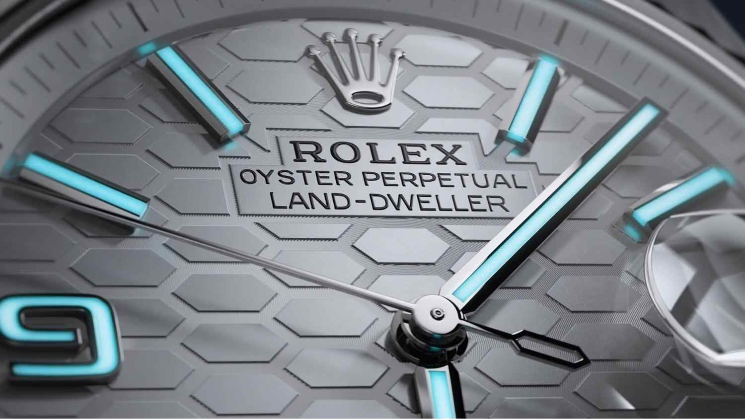 A video preview for the Rolex Land-Dweller, featuring a close-up of the watch's honeycomb dial. Its luminescent indices are glowing a subtle, bluish-green colour.