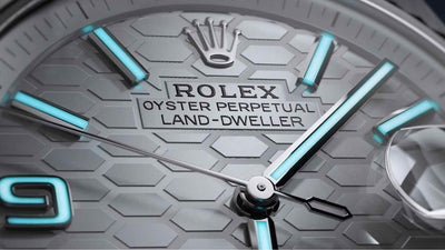 A video preview for the Rolex Land-Dweller, featuring a close-up of the watch's honeycomb dial. Its luminescent indices are glowing a subtle, bluish-green colour.