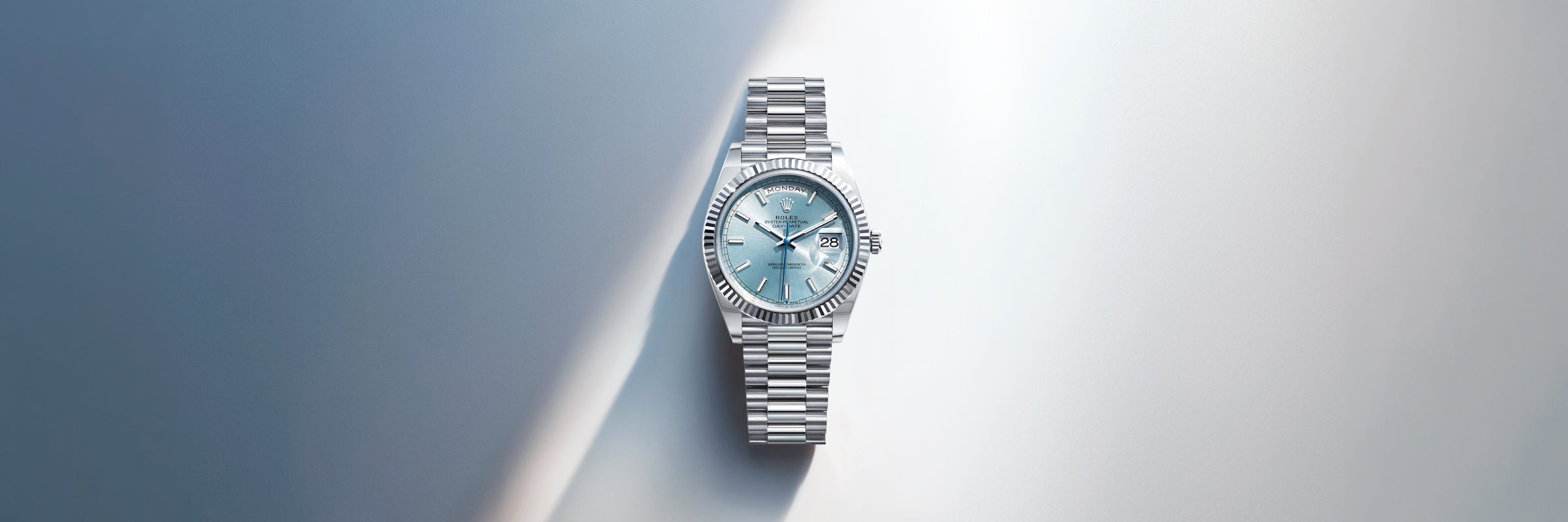 Rolex Day-Date with an ice blue face on a gradient background