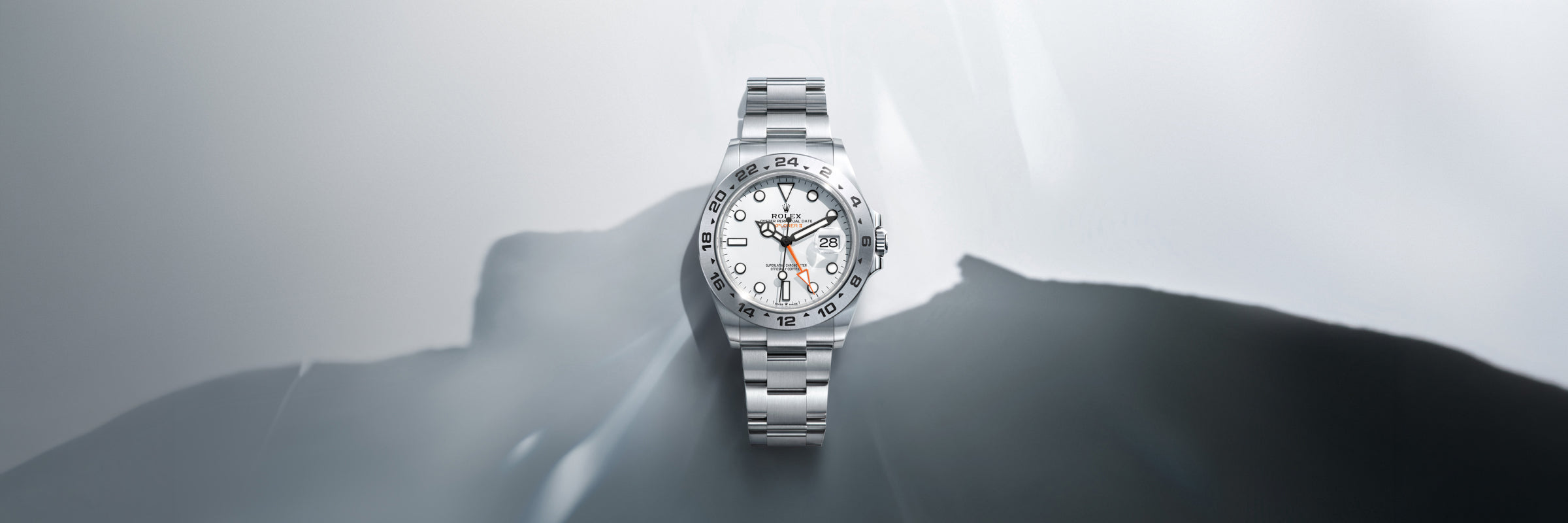 Rolex Explorer II with a white dial on a grey background