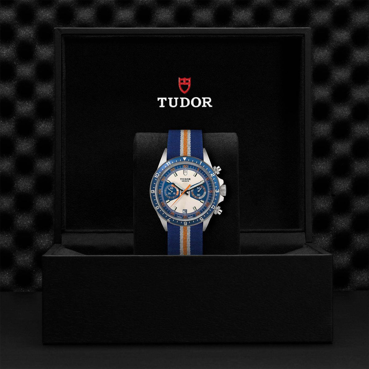 Tudor Heritage Chrono 42mm steel case with a opaline and blue dial and a fabric strap - Howard Fine Jewellers